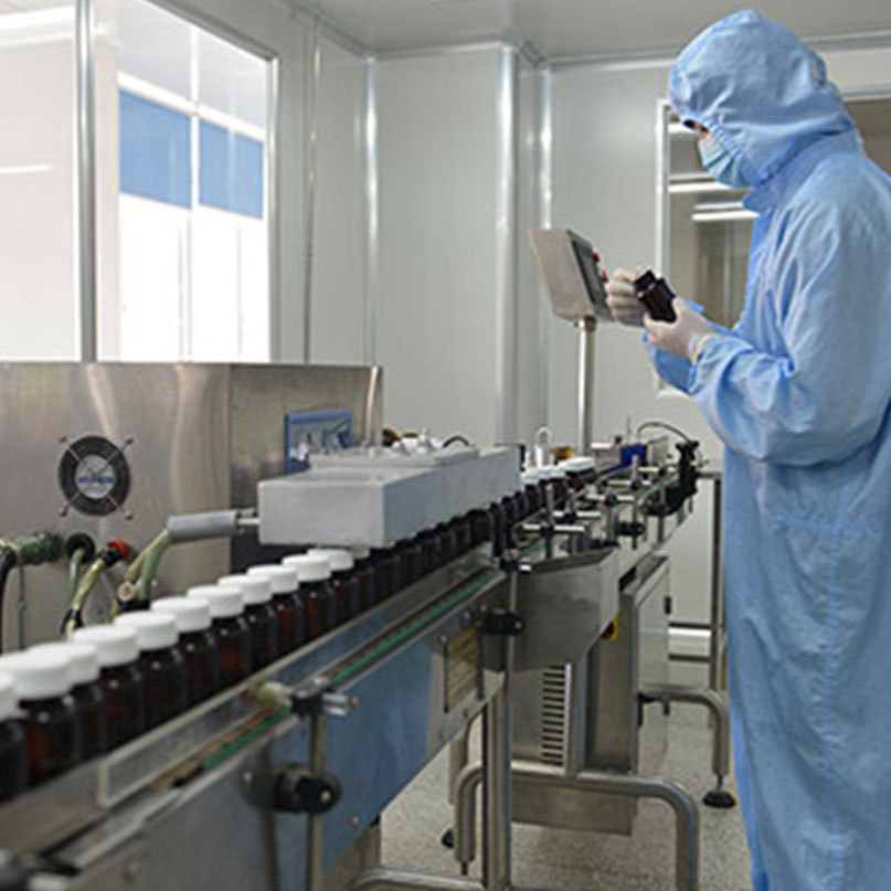 Worker wearing protective gear while working in a lab.