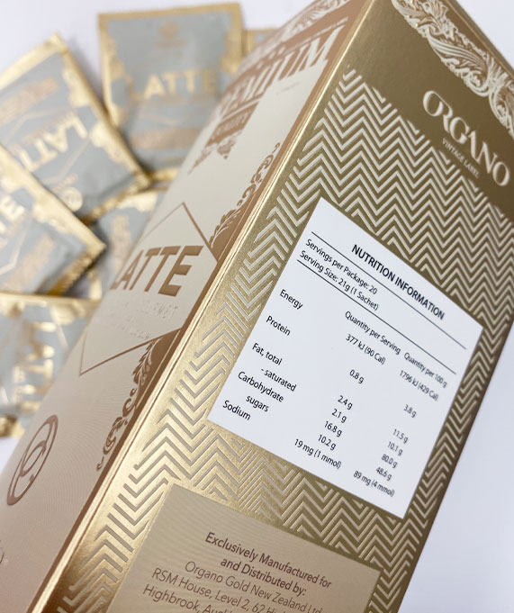 Gold Organo Latte box with packets behind.