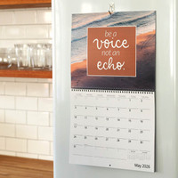 Wall calendar for May 2026 featuring a beach image with the quote “Be a voice not an echo” above the monthly date grid.