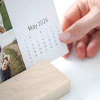 The modern maple wood block stand displays your personalized calendar with effortless style and stability