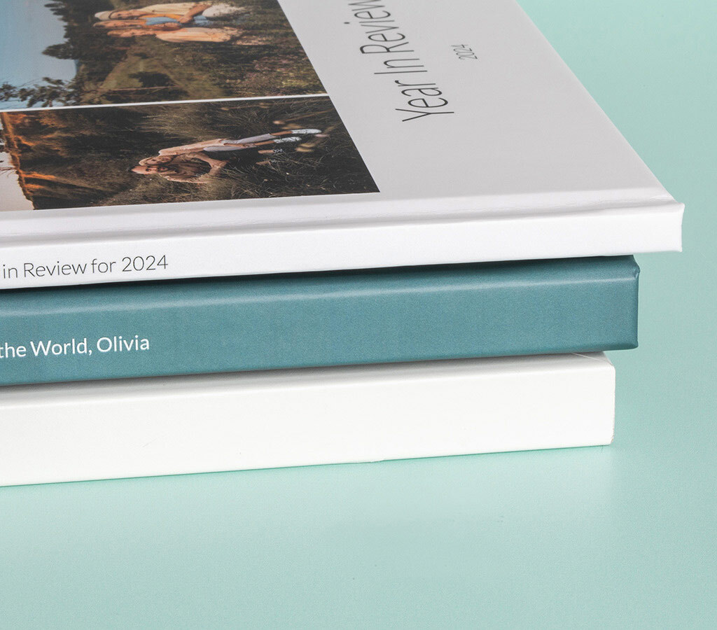 A collection of hardcover, softcover, and layflat photo books, each offering a unique way to showcase your memories.