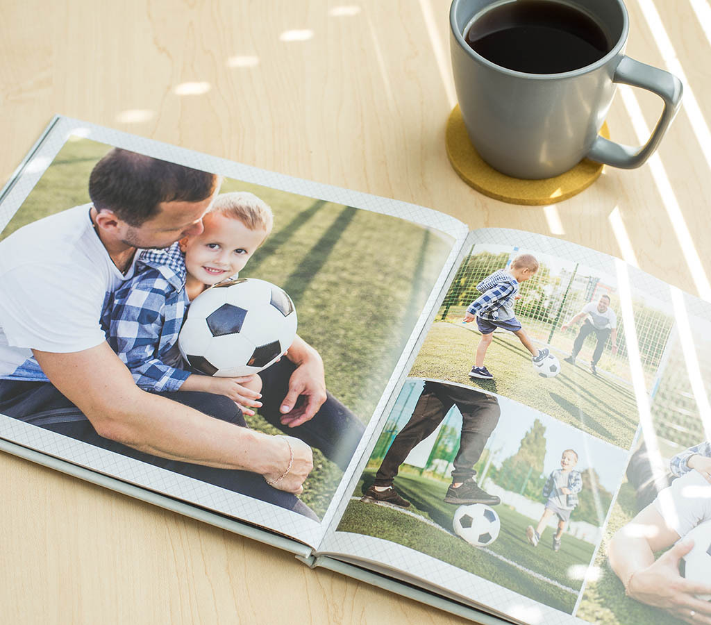 Hardcover photo book featuring father and son playing soccer