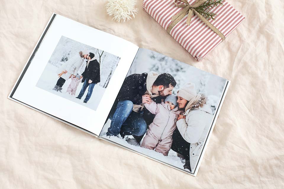 A custom hardcover photo book showcasing family time in the snow.