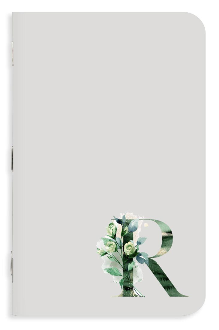 Elegant notebook design with subtle monogram details and accents.