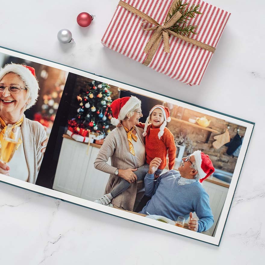 Relive your favorite Christmas moments with a luxurious layflat photo book designed to showcase holiday memories in full detail