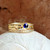 Solid gold PEI Stack featuring sand band, oceanside wave ring, and gemstone stacking ring