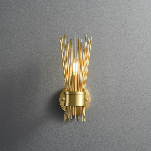 Front view of an illuminated Single Starburst Sconce Natural Brass wall light, showing the brass starburst structure radiating outwards from the center, with a lit bulb in the middle.