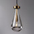 An illuminated Rachael Pendant Brass light, showing a clear waterdrop-shaped glass shade with the light source visible inside and a top fitting with a burnished brass finish.