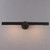 Front view of an illuminated Antoni Picture Light Bronze, showing the effect of light casting downwards from the bronze tubular head.