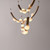 Side angle view of the illuminated Crescent Moon Brass Pendant Light, showing the glowing effect of the orb lights (alabaster material) arranged on the tiered brass crescent frames.
