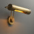 Side view of the illuminated Chole Tube  Picture Light, showing light emitting from the gold metal tubular head and the bend of the adjustable arm.