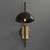 Front view of an illuminated Zack Dome Wall Sconce wall light, showing the dome-shaped shade, metal components connecting the adjustable arm, and the round wall base.