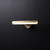 Side view of an illuminated Geometric Brass Wall Light, showing its angular metal geometric shape and light emitting from the front.
