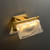Side view of an illuminated Cloud Glass Wall Sconce wall light, showing its layered cloud-like glass shades and the metal base connecting to the wall, with soft light emanating.