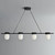 An unlit Erica Alabaster Linear Pendant 4 Lights, viewed straight-on, showing four capsule-shaped natural alabaster shades evenly spaced on a black metal bar.