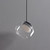An unlit Ava Layered Alabaster Glass Pendant showing the natural veining of the inner alabaster stone visible through the irregularly shaped clear glass outer shell, suspended by a dark metal fitting and black cord.