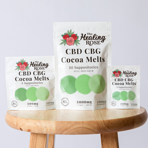 Three Healing Rose CBD CBG Cocoa Melts pouches on a round wooden stool