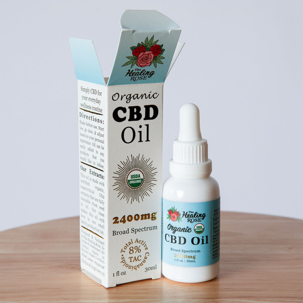 Organic Broad Spectrum CBD 2400mg CBD Oil with no detectable THC alongside its box by The Healing Rose