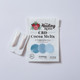 Healing Rose CBD Cocoa Melts 2 pouch on a light background with cocoa butter melts arranged around it