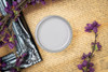Dixie Belle Paint Mason Dixon Gray Chalk Mineral Paint is the perfect paint for any DIY project! Can of Mason Dixon Gray Chalk paint Sitting on a scripted background with purple flowers.