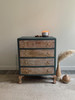 Dixie Belle Paint Stormy Seas Chalk Mineral Paint is the perfect paint for any DIY project!
Small dresser with wood drawers and the rest of the body is painted in Stormy Seas Chalk Mineral Paint with gold hardware. Staged with a burning candle on top.
