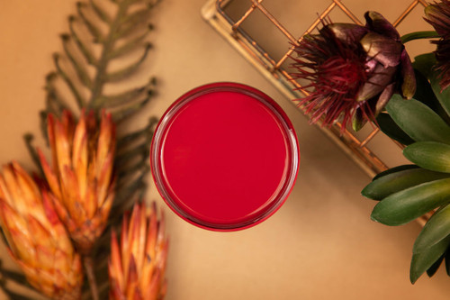 Fiery Sky Silk All-In-One paint is perfect for painting kitchen cabinets, bathroom cabinets and painting furniture.
Opened container of Fiery Sky Silk All-In-One paint staged with greenery and a copper basket