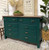 Midnight Green Silk All-In-One paint is perfect for painting kitchen cabinets, bathroom cabinets and painting furniture. Dark green Silk all in one painted dresser with wood stained top. Staged with a potted plant, a wood bowl with grass balls and a vase with wheat, also has a vision board wall décor on top.