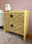 Belles and Whistles Safari - Stencil provides an extra decorative touch to any project! A yellow side table with 2 drawers featuring the cheetah stencil on the front painted in black.