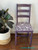 Elderberry Terra Clay Paint provides endless possibilities for your imagination and can be used on wood, canvas, tile, fabric and more! Purple clay painted chair with the Songbirds stencil applied in white paint. Large rubber plant in a white woven basket next to the chair.