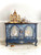 Blue chalk painted buffet with a dark wood top and brass handles. The Chinoiserie Transfer has been applied to the front of the piece and the Victorian Damask stencil has been applied in the background in gold.