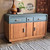 A vintage wooden sideboard with a teal top, three drawers, and three cabinet doors, accented with copper handles. A lamp and potted plant sit on top. The watermark “Retro Revival” is in the background.