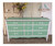 Dixie Belle Paint Mint Julep Chalk Mineral Paint is the perfect paint for any DIY project!
White chalk painted dresser with mint green chalk painted drawer fronts and top. Staged with a vase and yellow flowers.