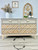 Dixie Belle Paint Mud Puddle Chalk Mineral Paint is the perfect paint for any DIY project! Dresser painted in Dixie Belle Paint Mud Puddle Chalk Mineral Paint with wood grain drawers and a line work painted on them. Staged with wooded arch, and some plants.