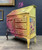 Dixie Belle Paint Rusty Nail Chalk Mineral Paint is the perfect paint for any DIY project! A secretary desk that has yellow and the rusty nail blended together with gold accents and a transfer on the side.