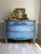 Belles and Whistles Morocco - Stencil provides an extra decorative touch to any project! 
Blue Chalk painted dresser with gold hardware, and light blue chalk painted morocco stencil on the front. Staged with pictures and a birdcage.