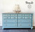 Serenity Silk All-In-One paint is perfect for painting kitchen cabinets, bathroom cabinets and painting furniture! A long dresser painted in serenity with a white stencil on the top drawers and silver hardware.