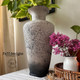 Onyx Terra Clay Paint provides endless possibilities for your imagination and can be used on wood, canvas, tile, fabric and more! Textured cream vase with Black clay paint on the bottom and splattered on the vase. Staged with plants.