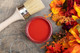 Dixie Belle Paint Barn Red Chalk Mineral Paint is the perfect paint for any DIY project! View of open container of Red chalk paint with a natural bristle brush which is the best brush for chalk paint.