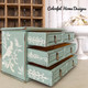 Dixie Belle Paint Sea Glass Chalk Mineral Paint is the perfect paint for any DIY project! A small jewelry box painted in sea glass and has a bird stencil on the side and lace stencils on the inside of the drawers in white.
