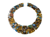 Make a statement in your style with this blue Impression Jasper and bronzite collar set from Dakota Stones. This set includes 15 focal beads in graduated sizes. You can use them all together to create a stunning statement necklace, or add a few to several different projects. There are plenty of beads to work with in this set. These gemstone beads feature gleaming swirls of bronze and brown, along with splashes of blue. Please note that these beads are made from composite gemstones.Because gemstones are natural materials, appearances may vary from piece to piece.Length 15.5-35.5mm, Width 23-29mm