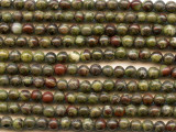 Forest green mixes with spatters of blood red color in the dragon blood jasper 4mm round beads from Dakota Stones. These small beads feature perfectly round shape and deep green color with a crimson red matrix. The two primary colors contrast and complement each other to form a striking jasper. This gemstone is mined in Australia. These beads would make perfect spacers and would look beautiful with copper components. Dragon blood jasper is part of the quartz family. Metaphysical Properties: Dragon blood jasper enhances courage, strength and vitality.Because gemstones are natural materials, appearances may vary from bead to bead. Each strand includes approximately 52 beads.