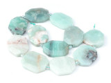 Decorate your jewelry designs with the gemstone style of these Dakota Stones beads. Black Gold Amazonite is a member of the Feldspar family and varies in hue from robin's egg blue to blue-green to black, occasionally mingled with rust-brown. This variety of Amazonite is actually a combination of Amazonite, Tourmaline and Pyrite. Amazonite is named for the Amazon River in Brazil, where the stones are thought to have been originally found, however they are not currently sourced from this region. The beads on this strand can range in size from about 20 x 30mm to 30 x 40mm. Because gemstones are natural materials, appearances may vary from bead to bead.