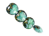 A fantastic display of style fills these Grace Lampwork beads. These beads feature a puffed round shape, perfect for showcasing in necklaces, bracelets, or even earrings. They feature seafoam color with a green shimmer of glitter and thin black stripes dancing through the color. Swirling patterns on the end of each bead complete the look. They're perfect for mystical mermaid styles.This item is handmade, so appearances may vary. Diameter 14.5-15.5mm, Length 13mm