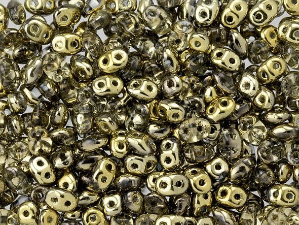 Clear color combines with metallic gold in these Matubo SuperDuo beads. Create intricate jewelry designs with Czech glass seed beads! Featuring a unique shape and two stringing holes, these seed beads add a special touch of creativity to your designs. They have tapered edges and nest up nicely when strung, making them ideal for floral and woven designs. Add a special touch to your jewelry with Czech glass seed beads!  