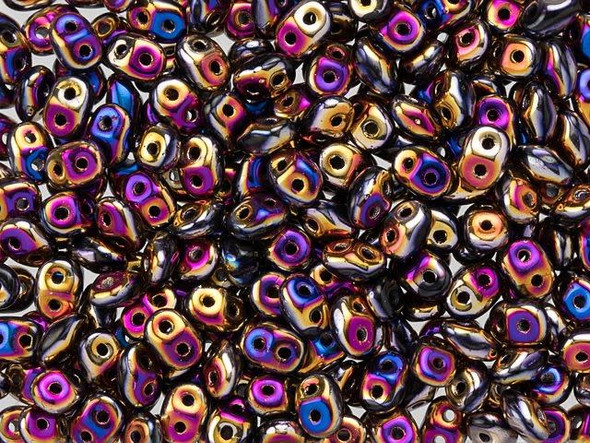 Bold black color contrasts with iridescent gold, purple, and blue tones in these Matubo SuperDuo beads. Create intricate jewelry designs with Czech glass seed beads! Featuring a unique shape and two stringing holes, these seed beads add a special touch of creativity to your designs. They have tapered edges and nest up nicely when strung, making them ideal for floral and woven designs. Add a special touch to your jewelry with Czech glass seed beads!  
