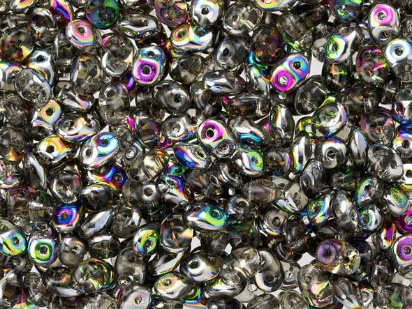 Shadowy grey color combines with an iridescent rainbow shine in these Matubo SuperDuo beads. Create intricate jewelry designs with Czech glass seed beads! Featuring a unique shape and two stringing holes, these seed beads add a special touch of creativity to your designs. They have tapered edges and nest up nicely when strung, making them ideal for floral and woven designs. Add a special touch to your jewelry with Czech glass seed beads!  