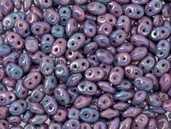 Shining lavender purple and baby blue tones gleam in these Matubo SuperDuo beads. Create intricate jewelry designs with Czech glass seed beads! Featuring a unique shape and two stringing holes, these seed beads add a special touch of creativity to your designs. They have tapered edges and nest up nicely when strung, making them ideal for floral and woven designs. Add a special touch to your jewelry with Czech glass seed beads!  