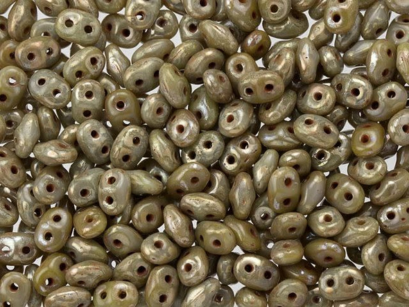 Golden-gray color creates a unique display in these Matubo SuperDuo beads. Create intricate jewelry designs with Czech glass seed beads! Featuring a unique shape and two stringing holes, these seed beads add a special touch of creativity to your designs. They have tapered edges and nest up nicely when strung, making them ideal for floral and woven designs. Add a special touch to your jewelry with Czech glass seed beads!  