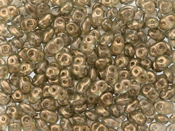 Neutral linen color with a halo of frosted golden shimmer fills these Matubo SuperDuo beads. Create intricate jewelry designs with Czech glass seed beads! Featuring a unique shape and two stringing holes, these seed beads add a special touch of creativity to your designs. They have tapered edges and nest up nicely when strung, making them ideal for floral and woven designs. Add a special touch to your jewelry with Czech glass seed beads!  