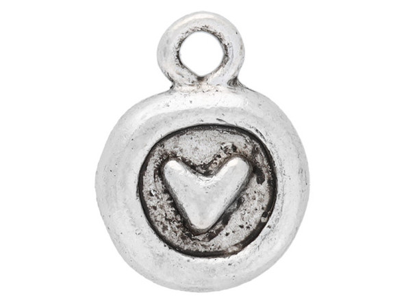 Put a touch of sweetness into designs with the Nunn Design antique silver-plated pewter Itsy circle heart charm. This tiny round charm features a raised design of a simple heart at the center. The recessed background is darker, so the heart will stand out in projects. The back of this charm is plain and smooth. A small ring at the top makes it easy to add to designs. This charm will add a lovely little accent to designs. It features a versatile silver shine. Hole Size 1.6mm/14 gauge, Length 12.5mm, Width 9.5mm